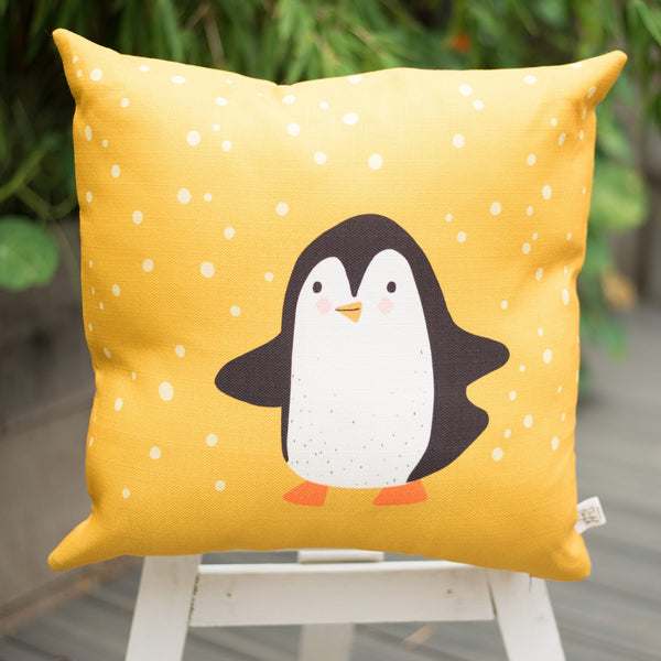 penguin throw pillow, mustard yellow cushion cover with a printed penguin children's illustration